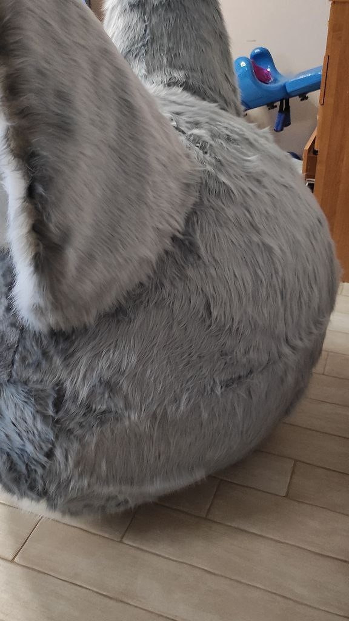 Round back of the giant fox head plush in grey faux fur with a tall pointed ear, sewn by hand to order