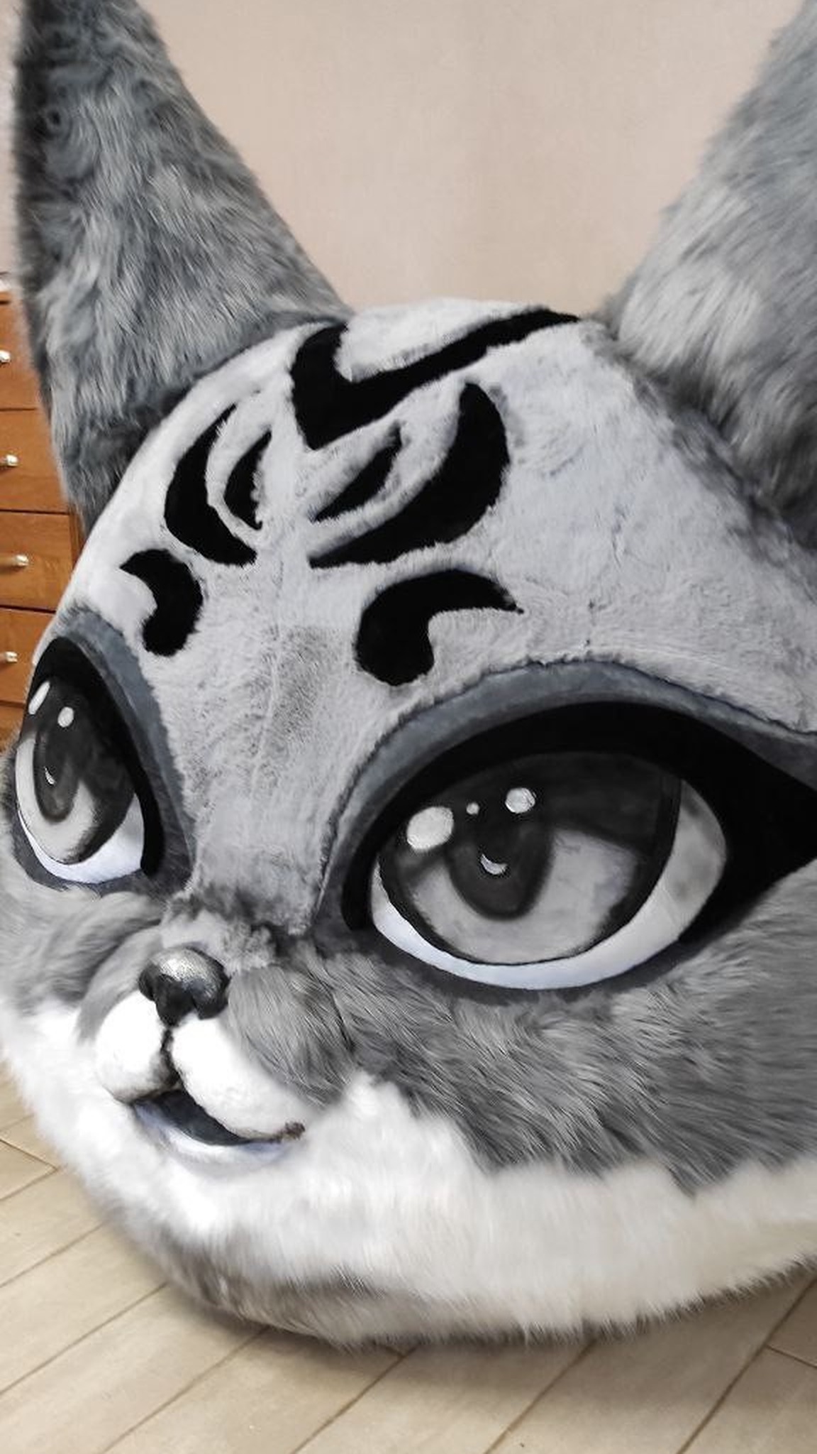 Custom giant fox head plush in grey and white faux fur, painted anime eyes and a glossy black nose, made to order