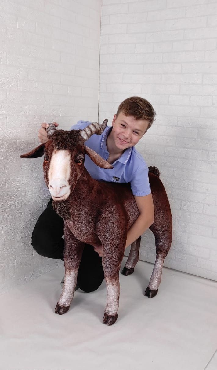 Giant goat stuffed animal with a boy Giant goat stuffed animal next to a kneeling boy, horns level with his head, handmade to order