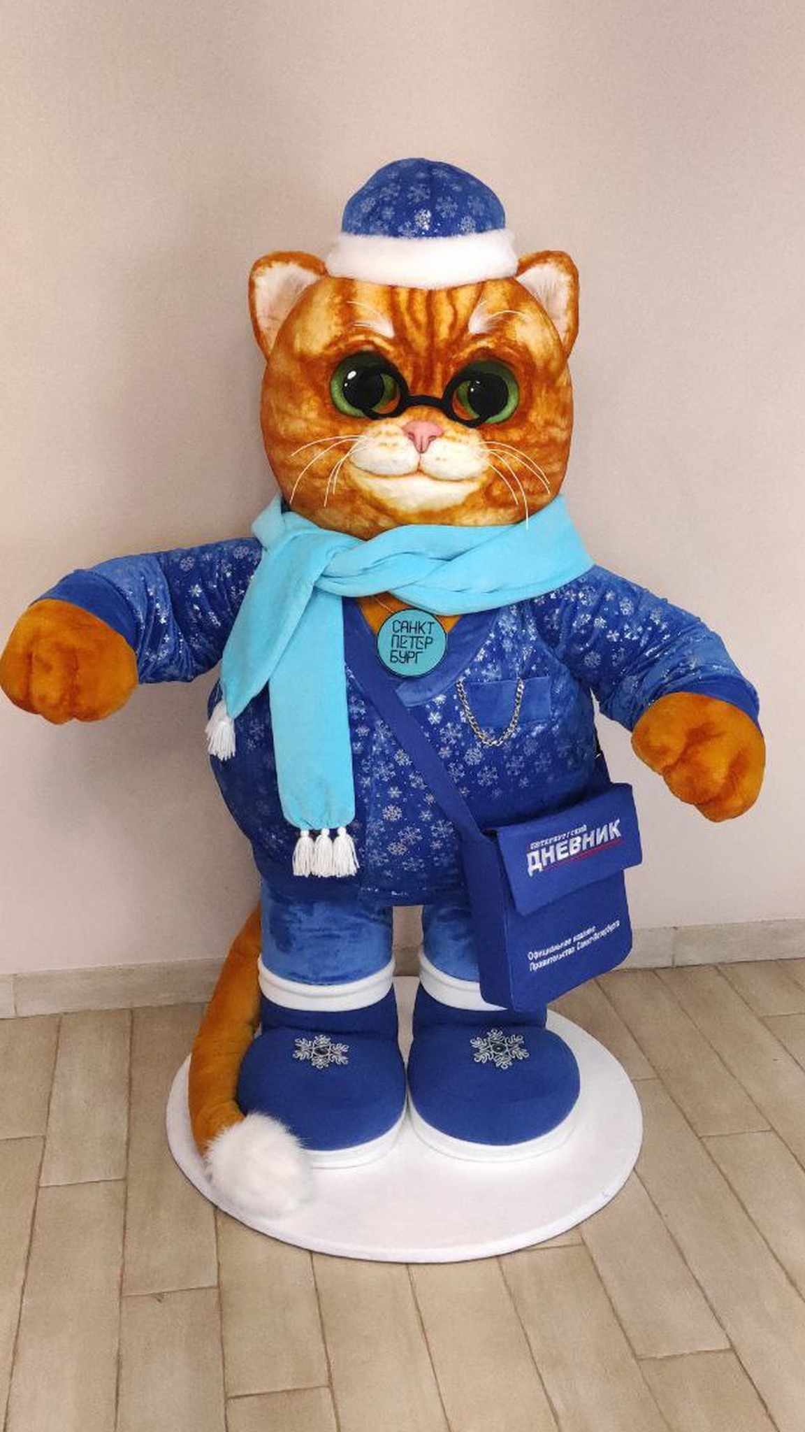 Giant plush cat mascot standing on a round white base, ginger tail with a white tip, handmade to order