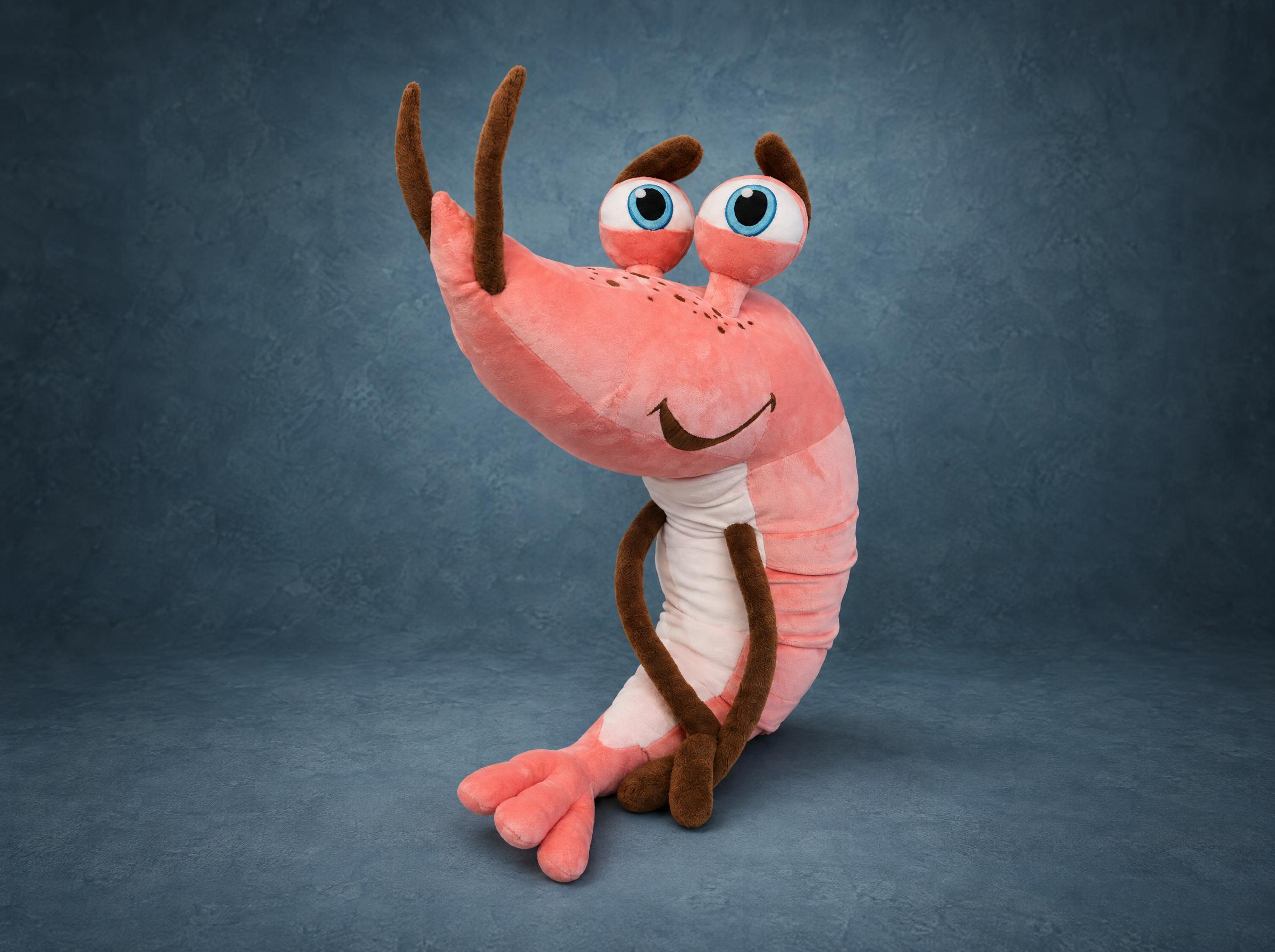 Giant shrimp plush mascot in pink with big blue eyes on stalks and brown legs, handmade to order from a drawing