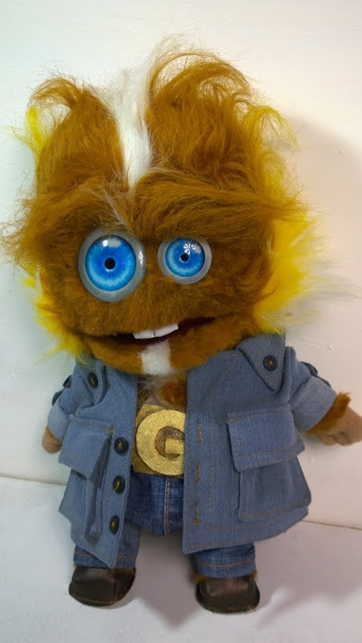 Ginger monster puppet with mismatched blue eyes, two buck teeth and a gold G belt buckle, made to order