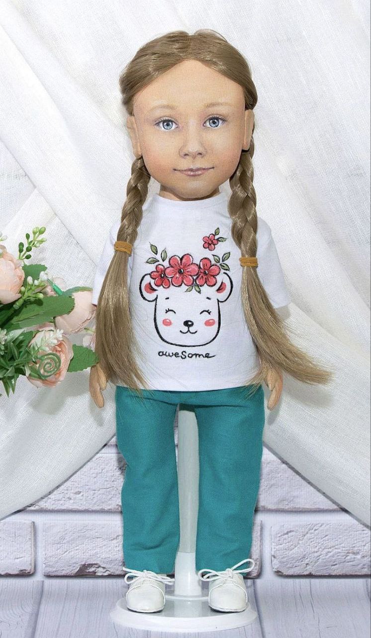 Girl portrait doll in her second outfit Girl portrait doll with two braids in a bear-print "awesome" T-shirt and teal pants, second outfit sewn to order