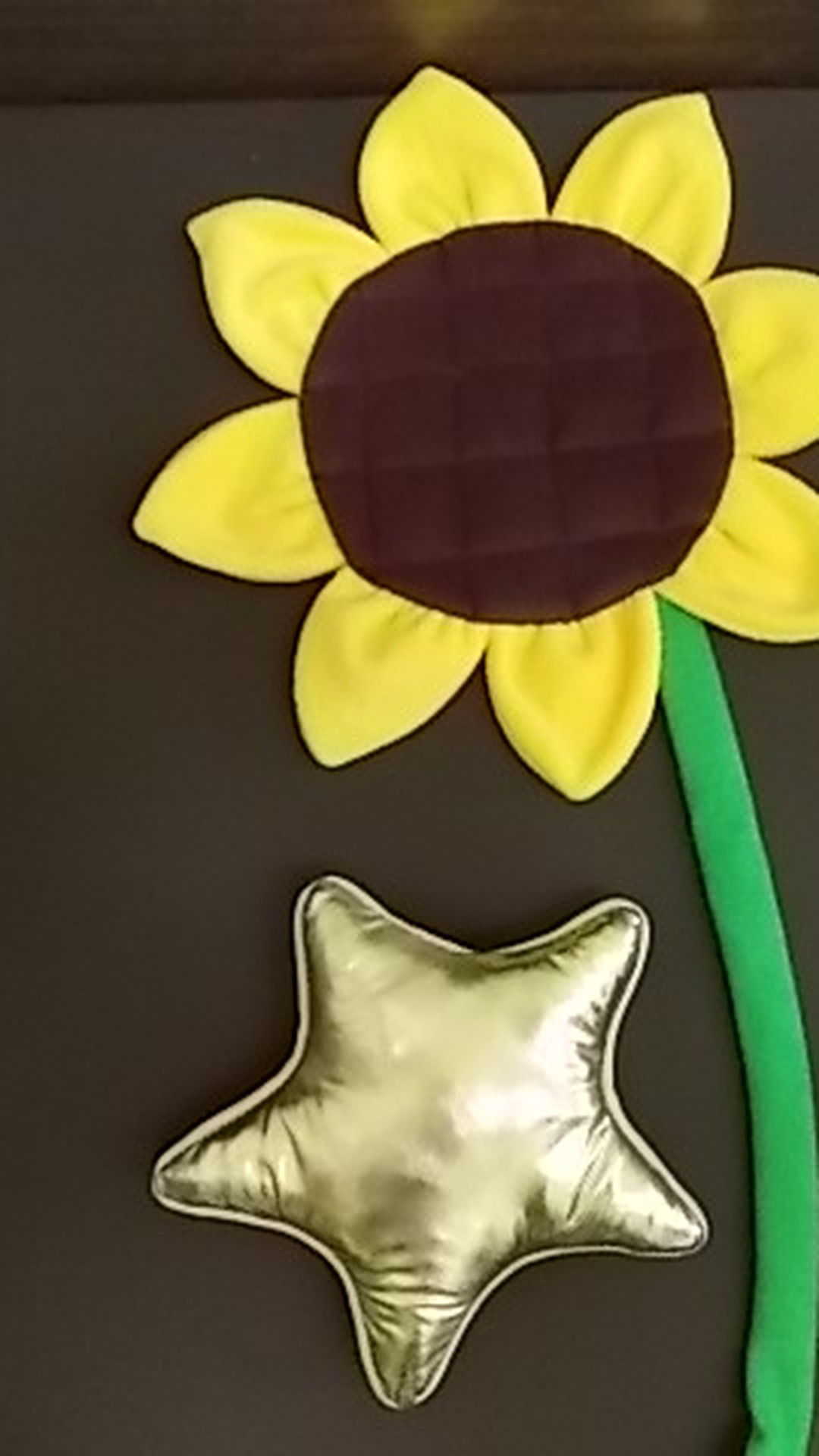 Metallic gold star cushion and a yellow sunflower with a long green stem, studio photo props made to order