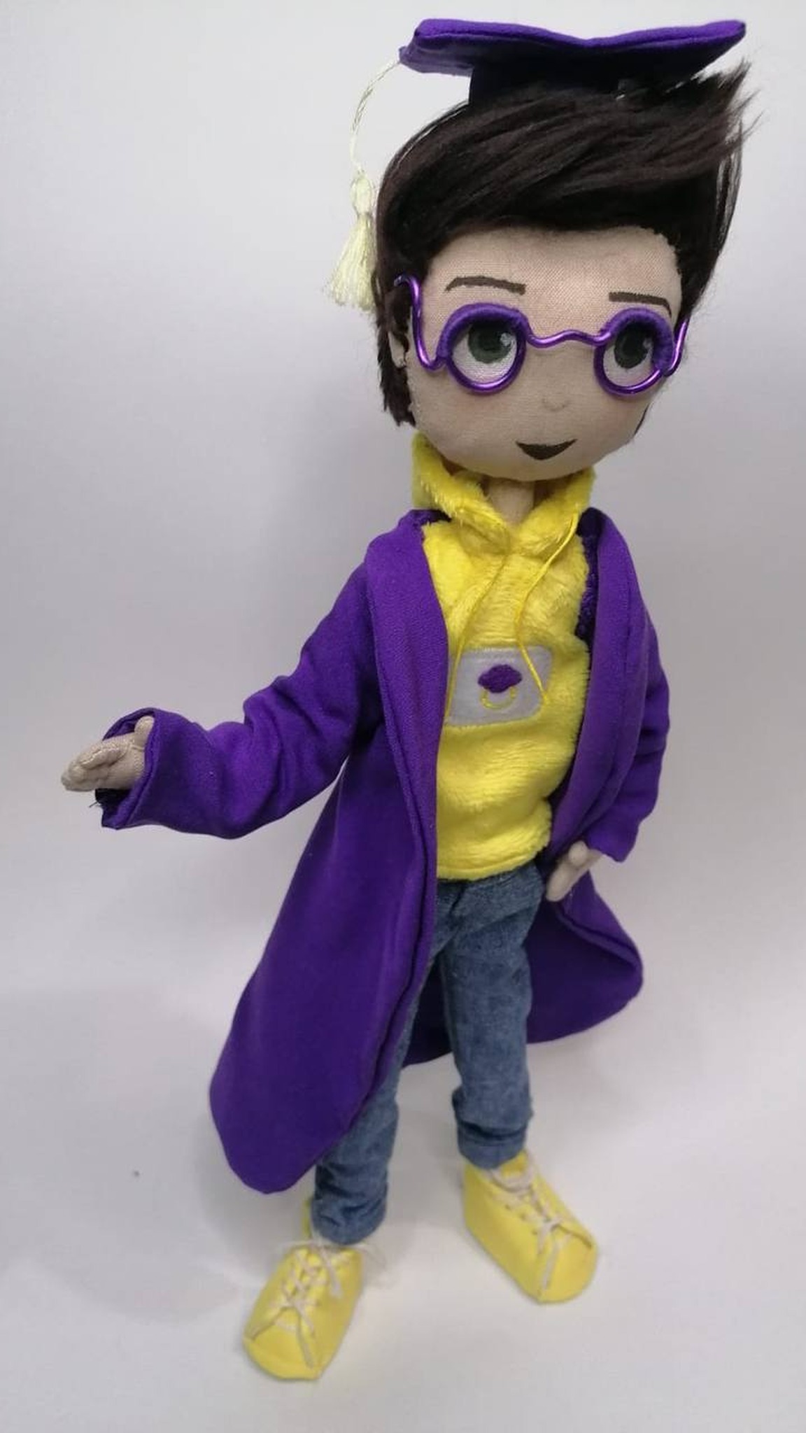 Graduate mascot doll with a cream tassel on his violet cap and round wire glasses, handmade to order
