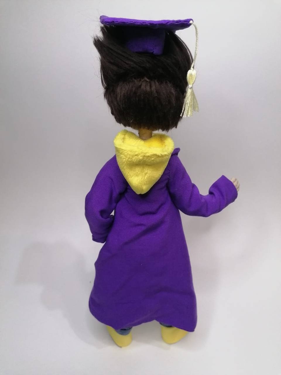 Graduate mascot doll gown and hood Graduate mascot doll gown with a yellow plush hood and violet mortarboard, handmade to order for a brand