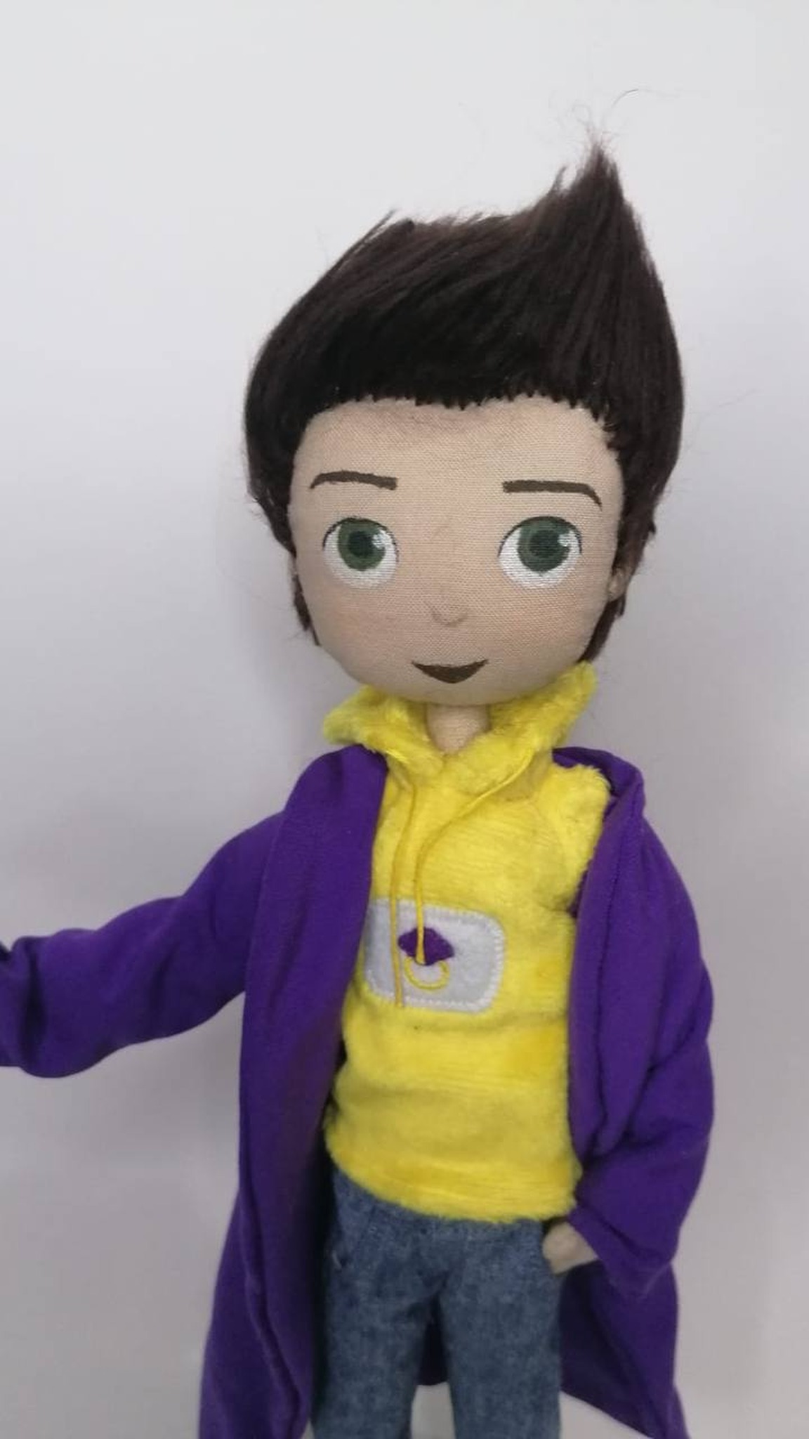 Mascot doll in a violet gown over a yellow hoodie with a chest patch, sewn by hand to order