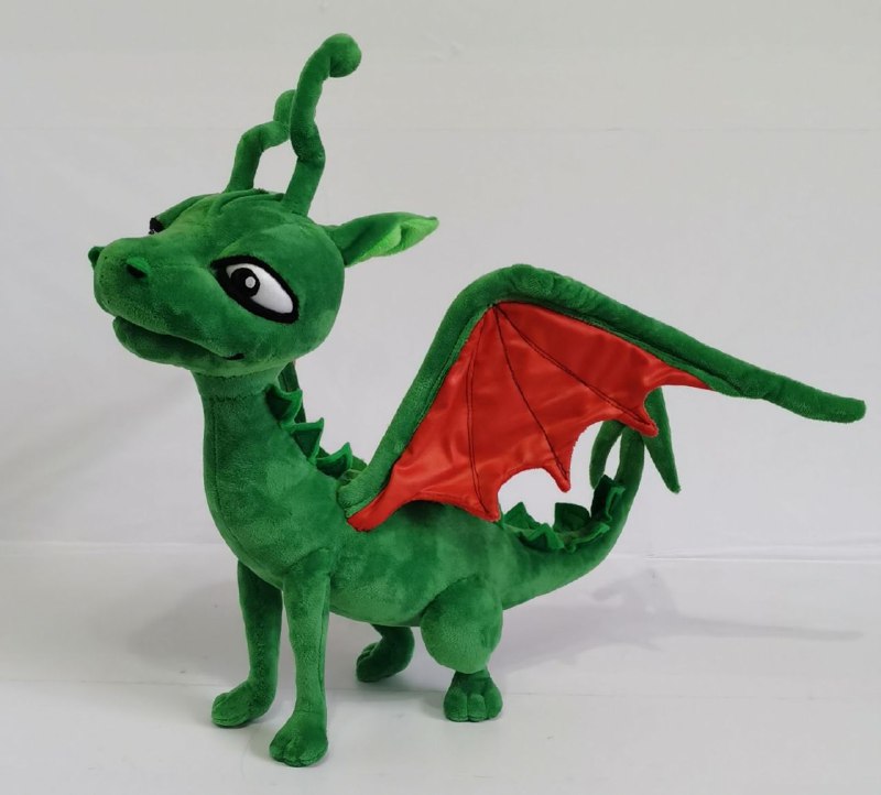 Green dragon plush with red-lined wing Handmade green book dragon plush with a raised red-lined wing and green back spikes, a custom dragon toy