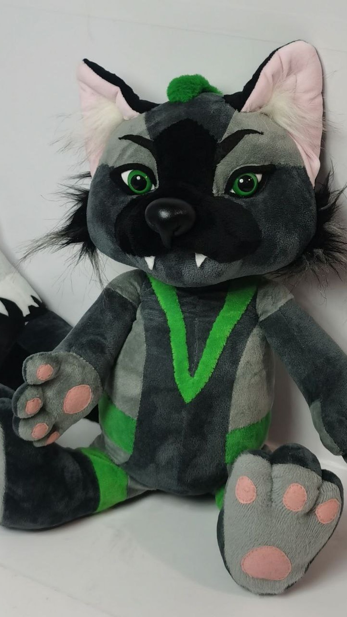 Grey fox fursona plush with green markings, fangs and pink paw pads, handmade from a ref sheet