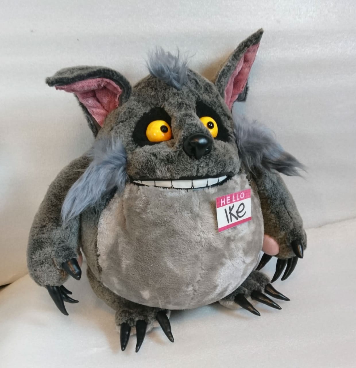 Grey monster plush with pink ears and black claws Grey monster plush with pink ears, black claws on hands and feet and a toothy smile, custom made to order