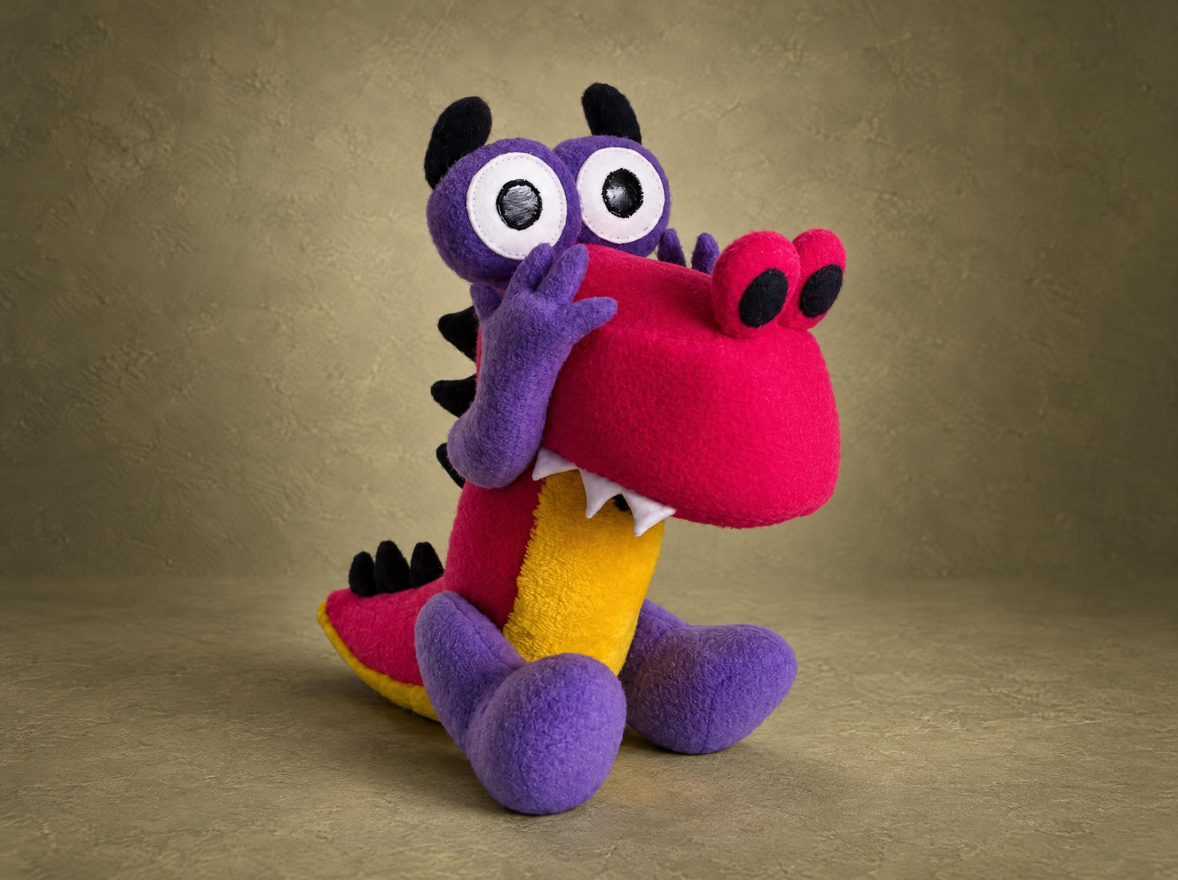 Custom dinosaur plush Grisha from Zavriki with a purple horned head, big eyes and a pink snout, made to order