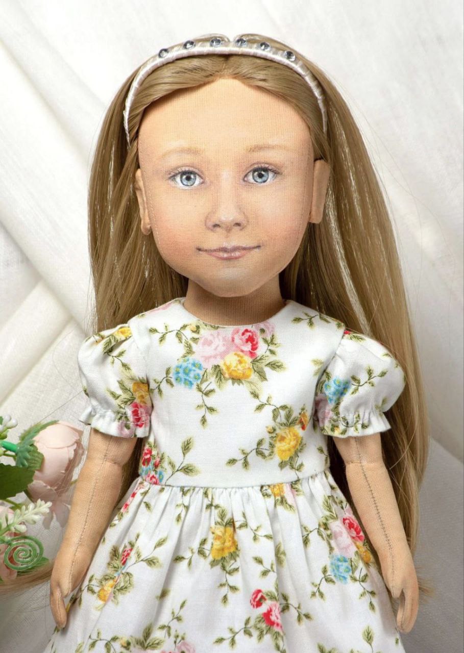 Hand-painted face of a girl portrait doll Hand-painted face of a custom girl portrait doll: blue eyes, soft smile, white headband, long dark-blonde hair