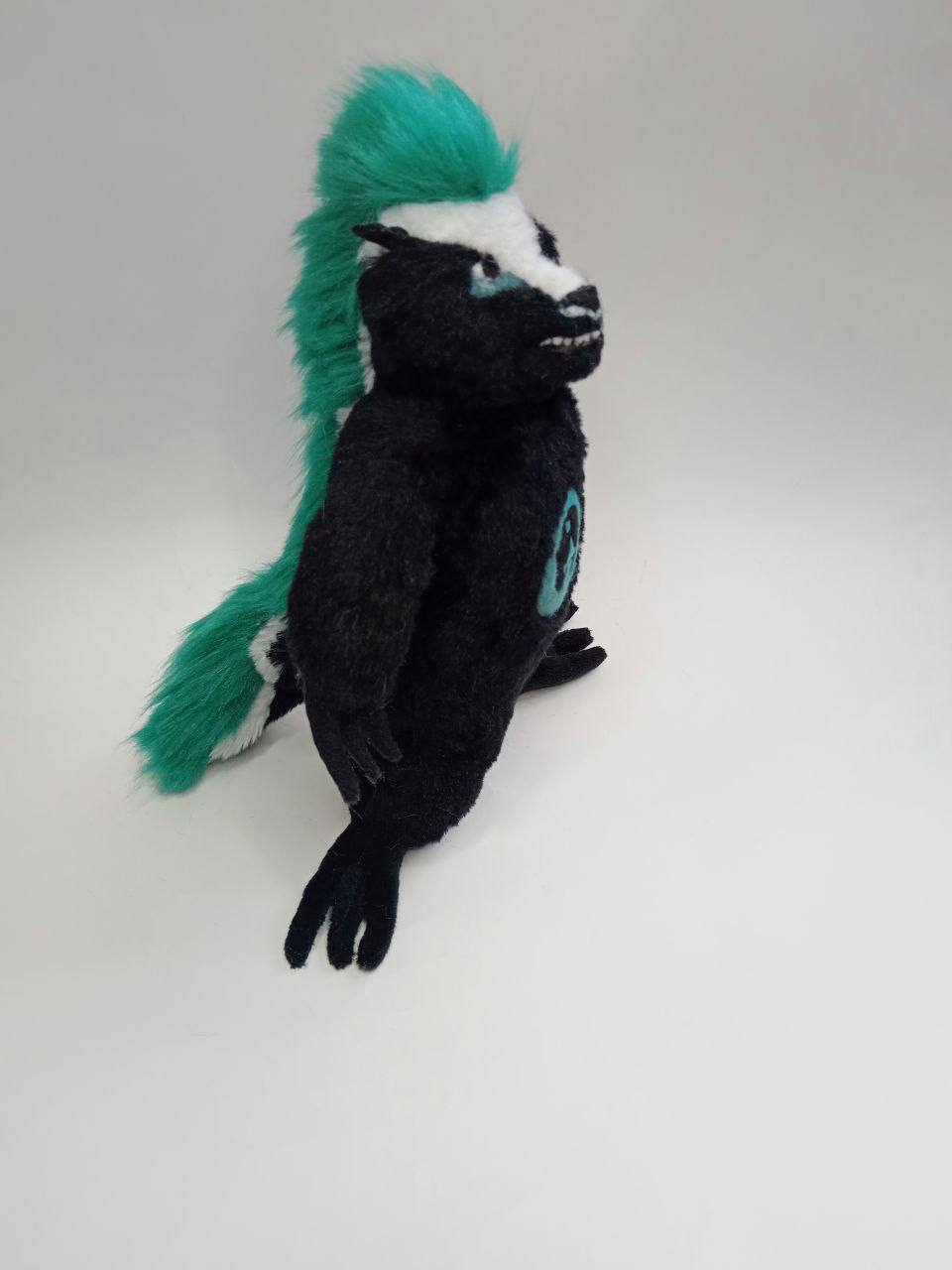 Honey badger mascot plush with mohawk Honey badger mascot plush with a long teal faux fur mohawk running down its back, handmade to order