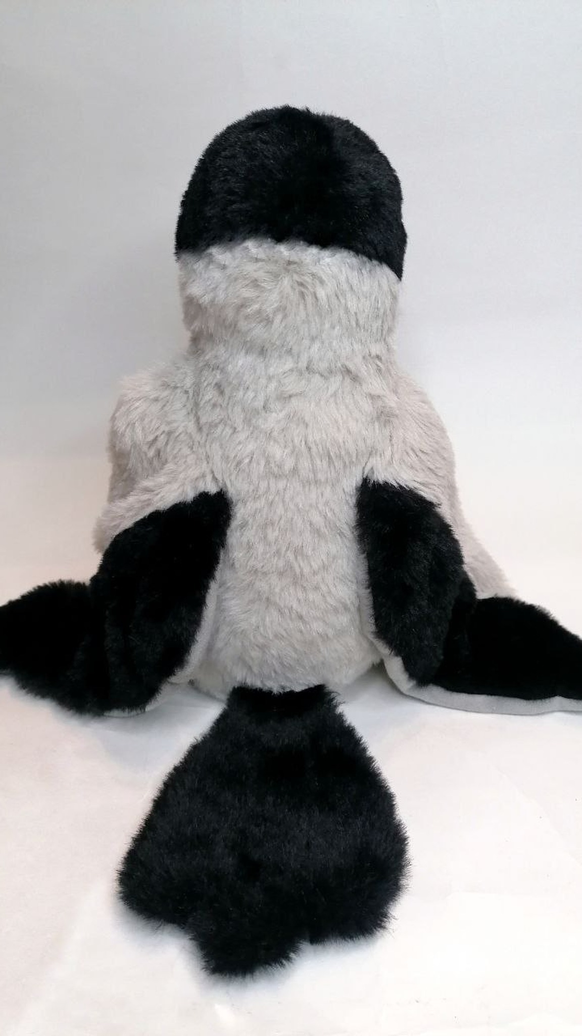 Hooded crow plush with black wing tips and a wide black tail on a grey back, handmade to order