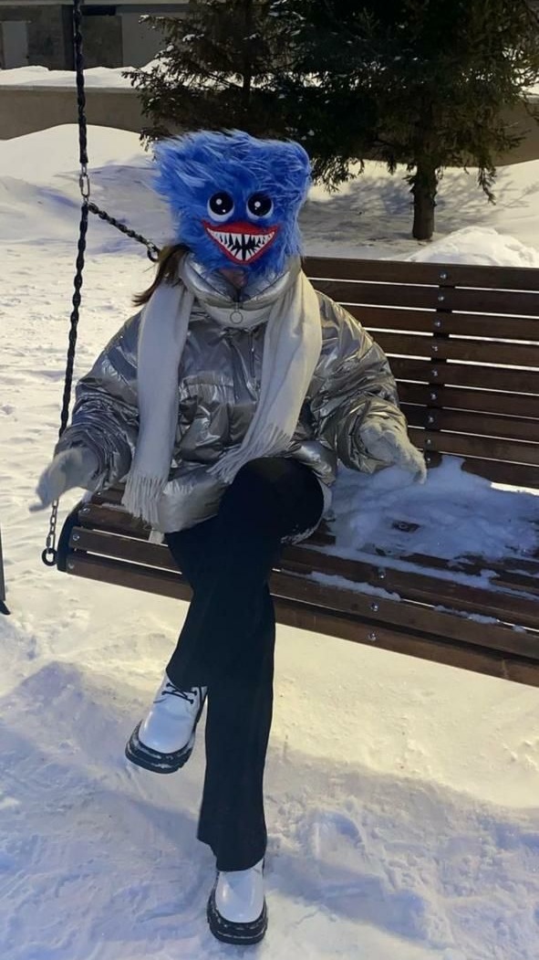 Huggy Wuggy plush hat worn as a costume head in winter Huggy Wuggy plush hat pulled down like a costume head on a snowy swing, custom made to order