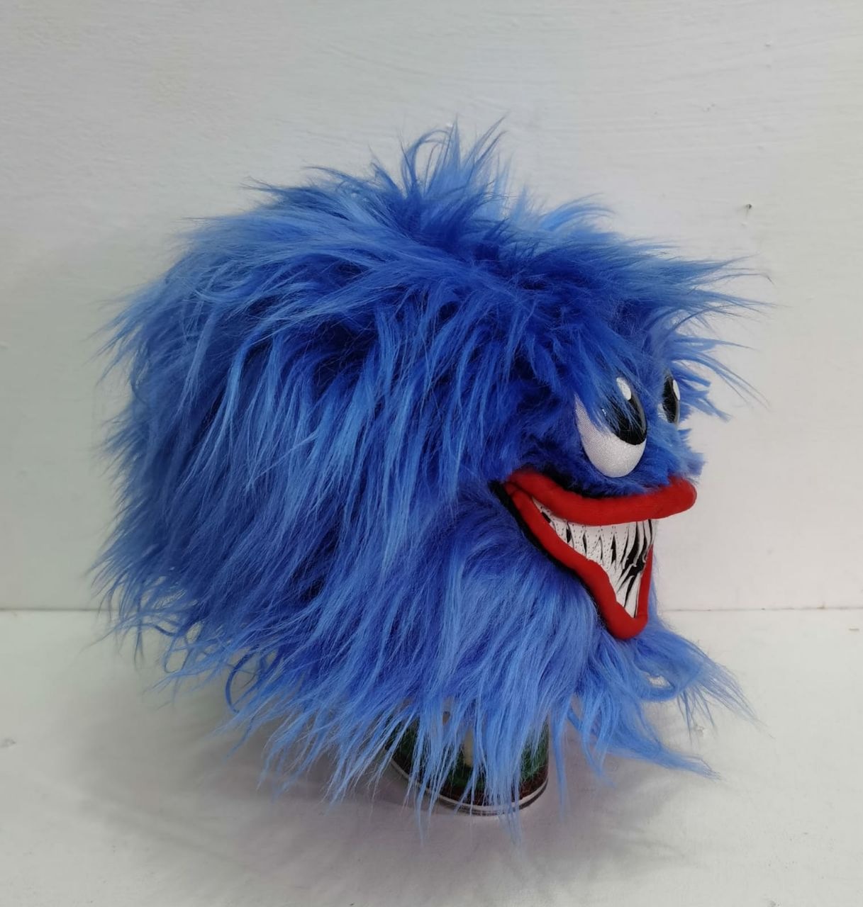 Wearable Huggy Wuggy plush head in blue faux fur Wearable Huggy Wuggy plush head with long blue faux fur falling over the sides and a red grin, handmade