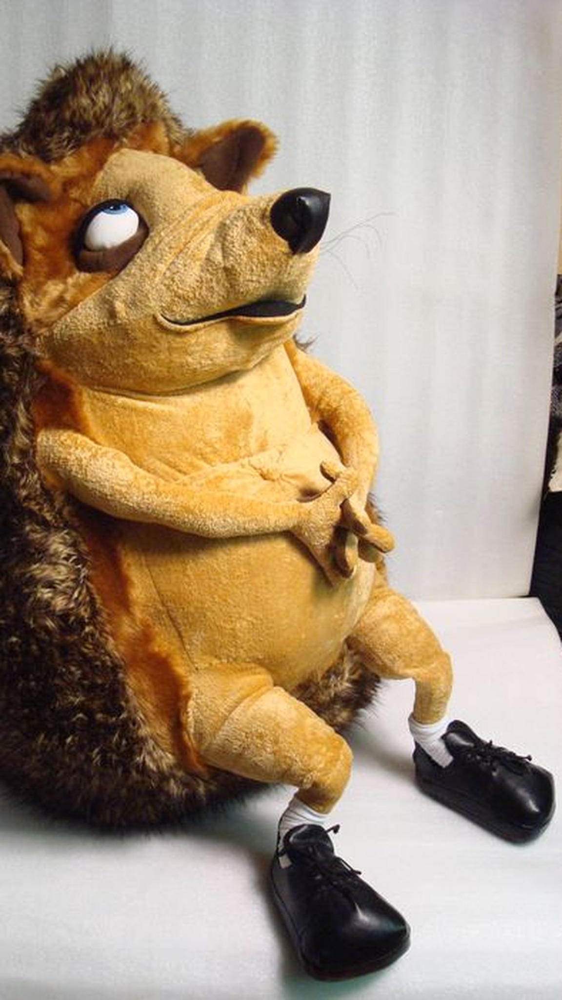 Large hedgehog plush toy made to order from a drawing: thick faux fur spines, paws folded on his tummy