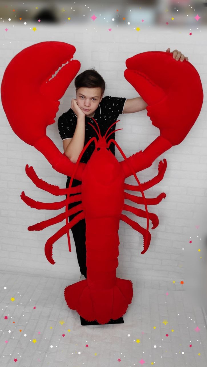 Life-size lobster plush mascot Life-size lobster plush mascot with a teenager standing between its claws for scale, custom made for a bar