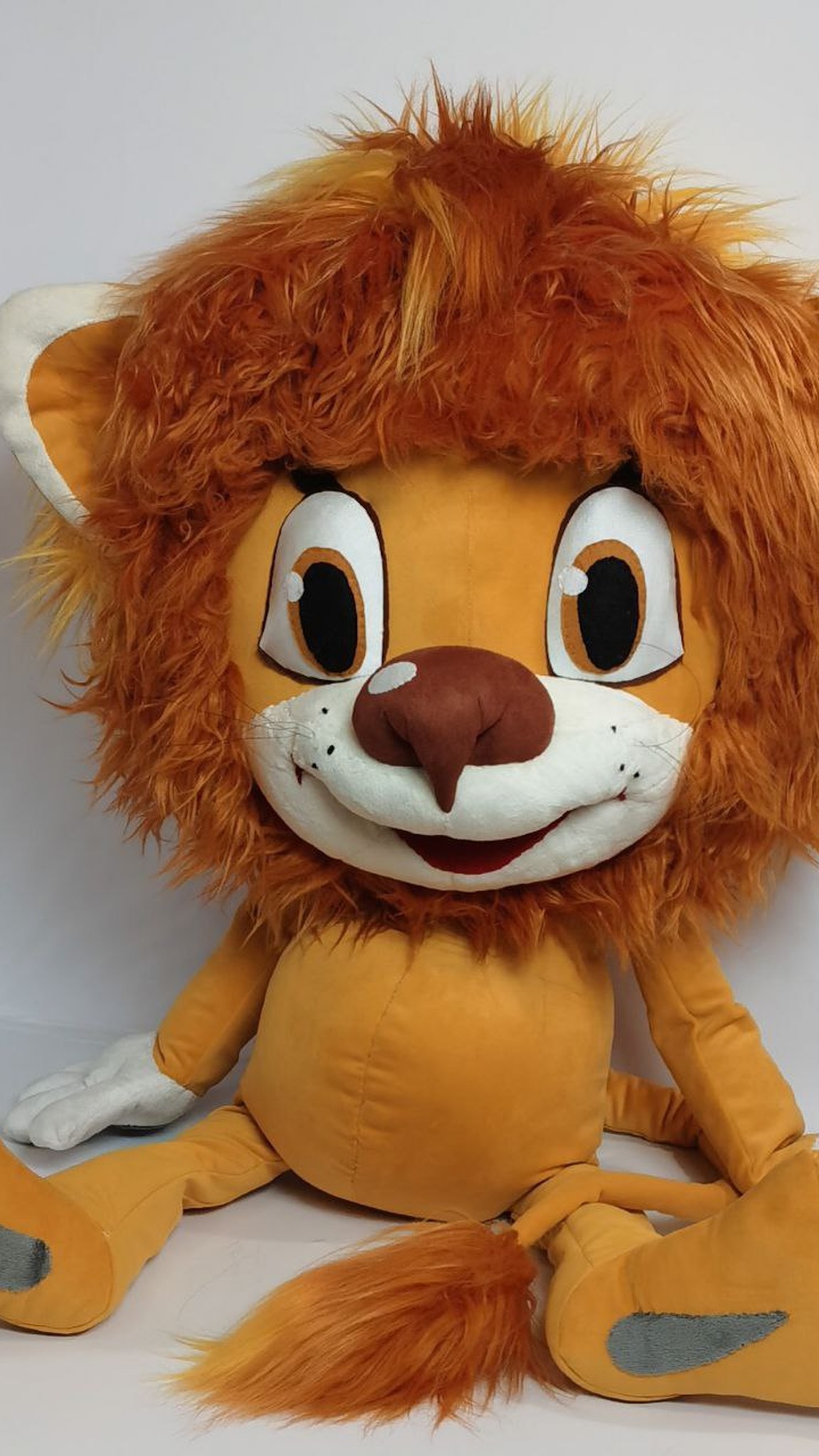 Custom lion cub plush with amber-brown eyes and a shaggy ginger mane, handmade to order