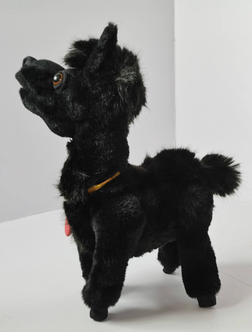Llama plush from a photo with a monogram tag Llama plush from a photo looking left, black faux fur and a red monogram tag on a yellow ribbon, handmade