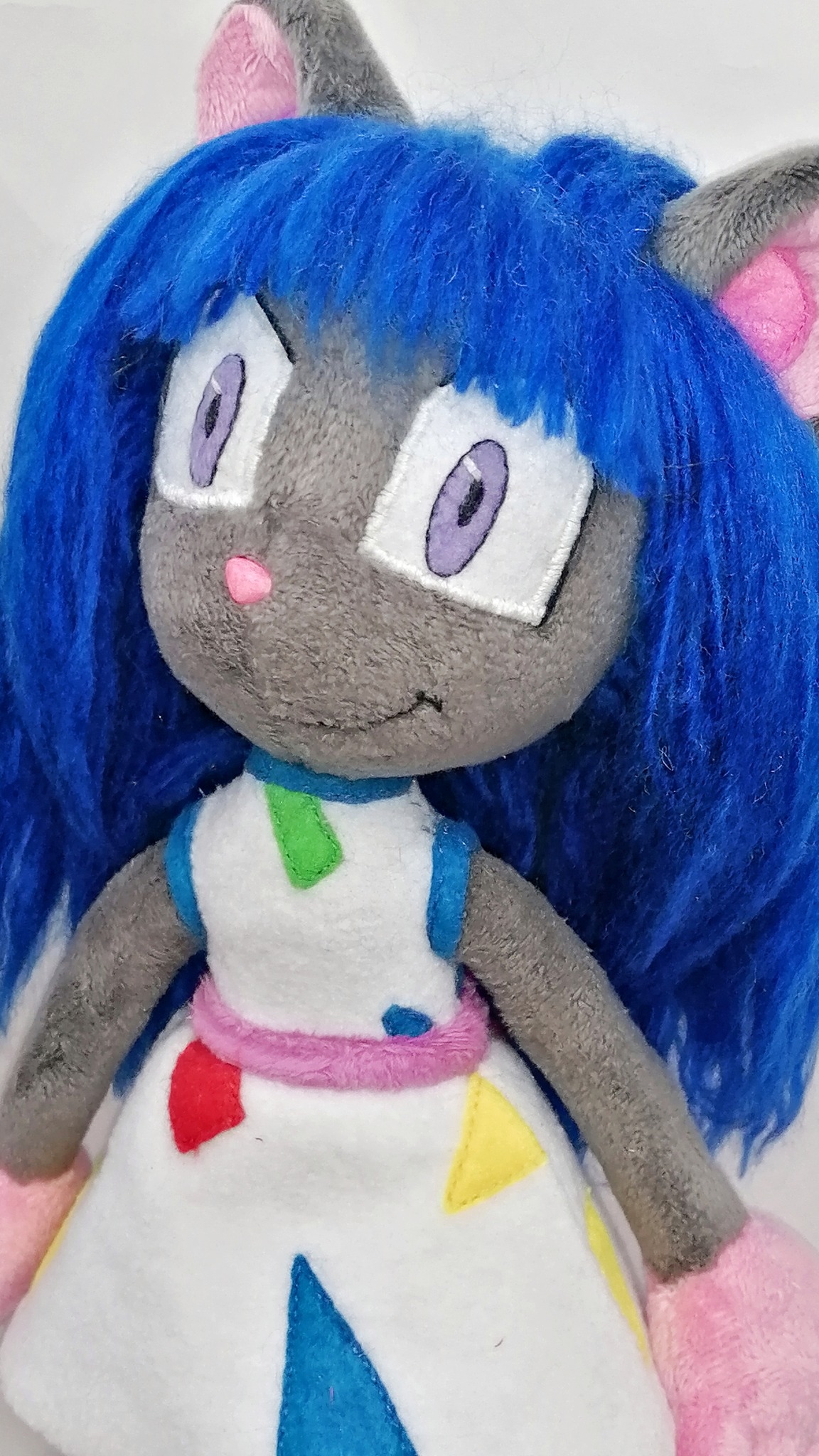 Face of the Magistra OC plush: lavender eyes, pink nose, blue bangs and a smile, custom mouse doll to order