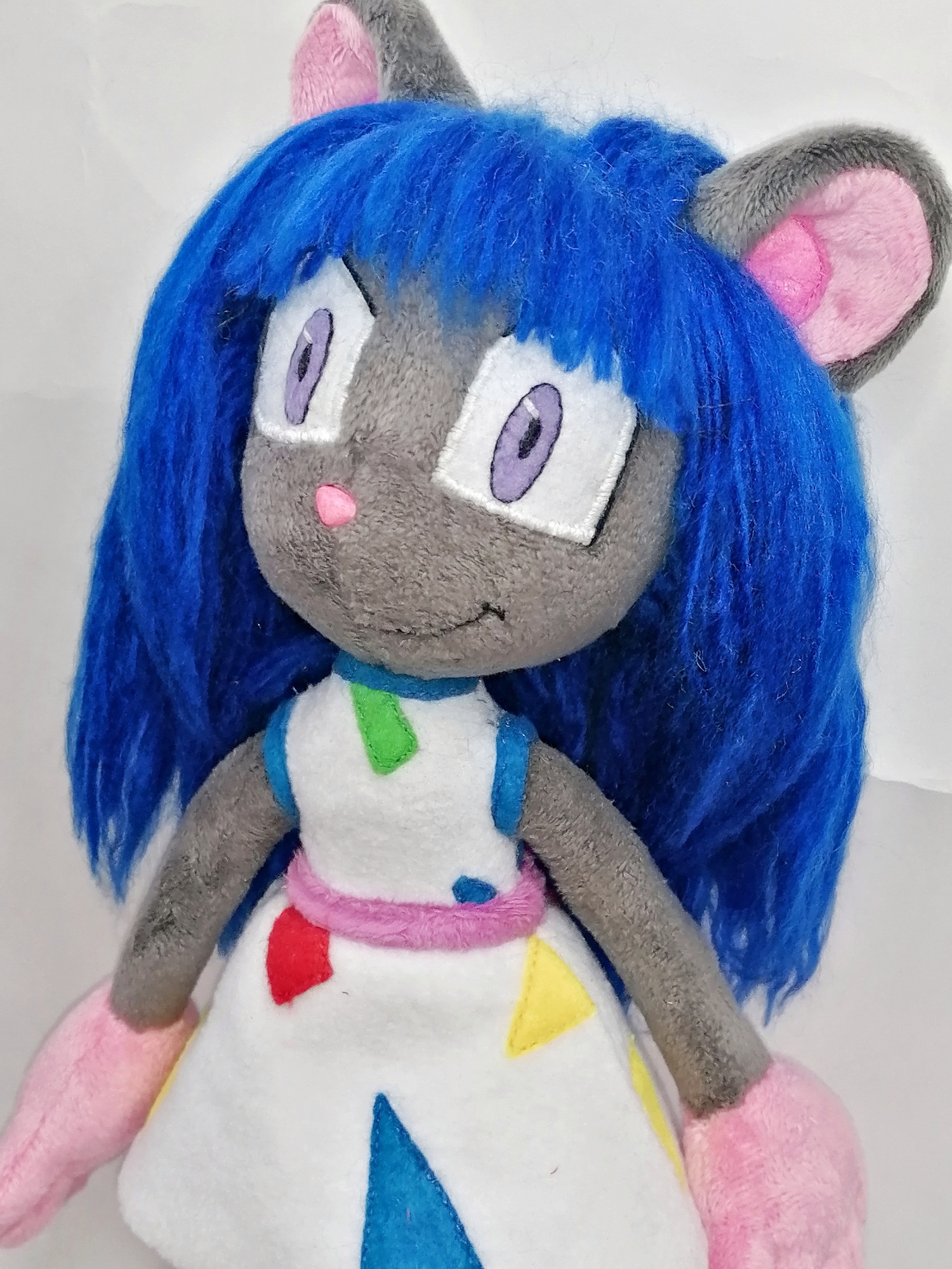 Magistra OC plush face Face of the Magistra OC plush: lavender eyes, pink nose, blue bangs and a smile, custom mouse doll to order