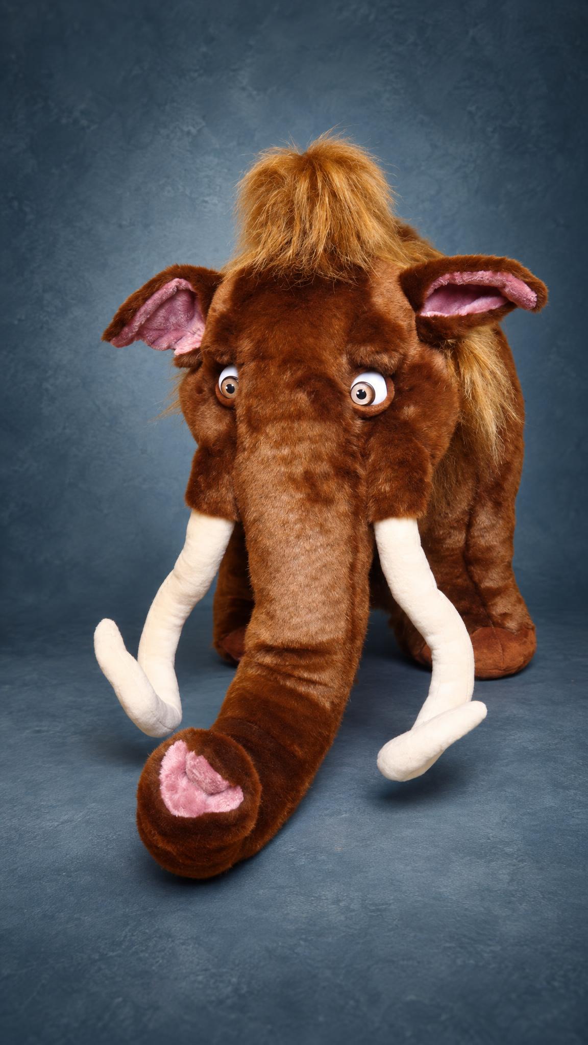 Manny the mammoth plush from Ice Age with a long brown trunk, pink inner ears and big round eyes, custom made
