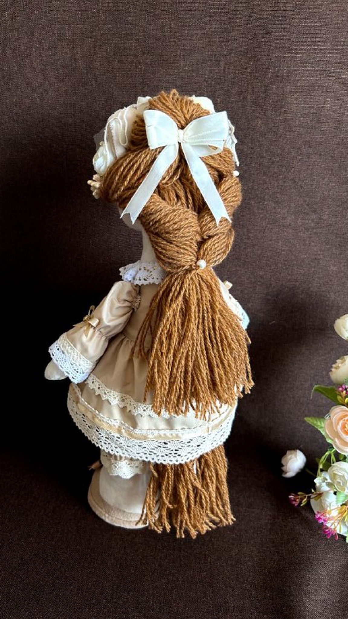 Mare horse plush with a braided yarn tail and a cream ribbon bow on her hat, custom made to order