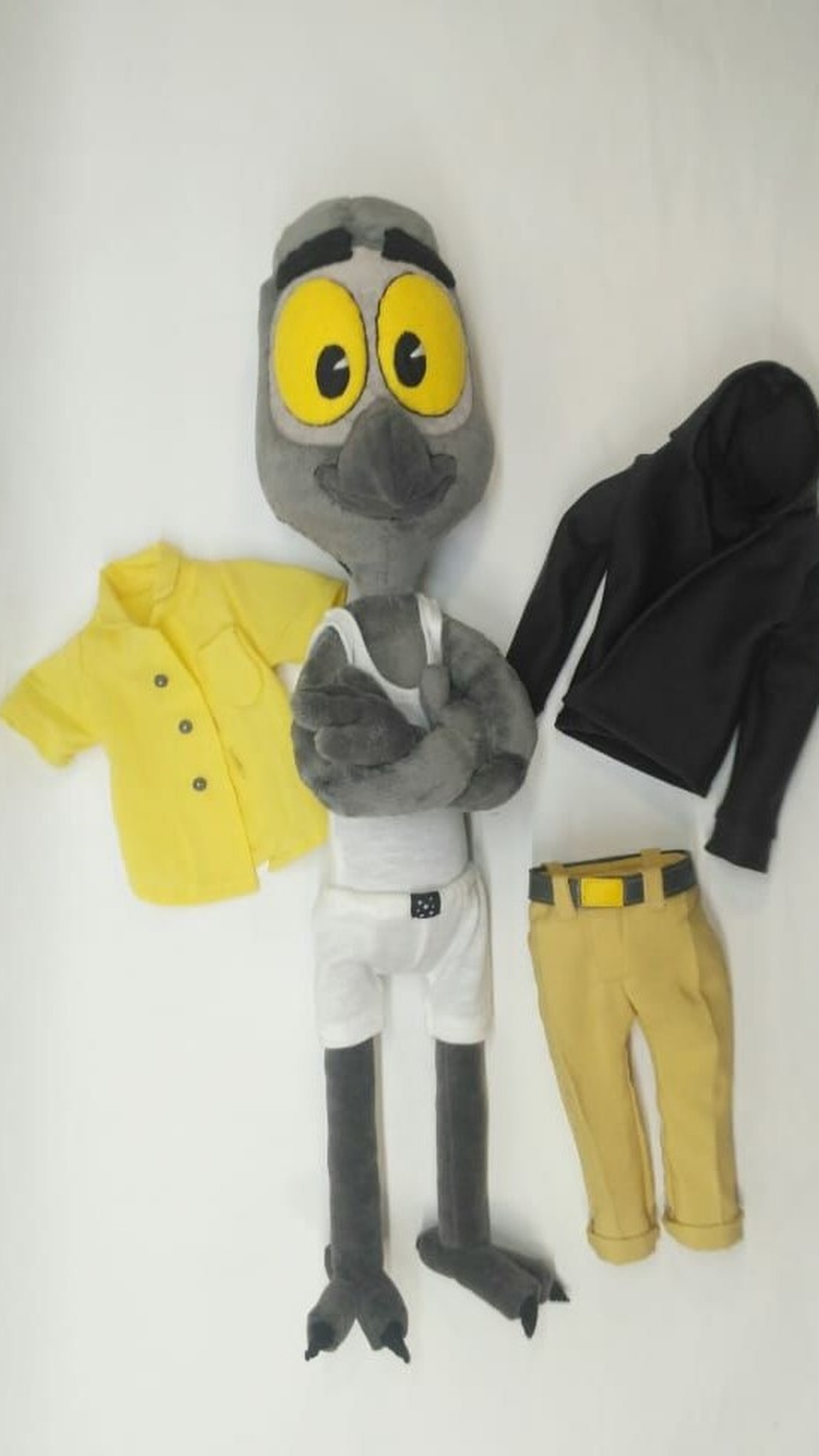 Mark Beaks plush in a white tank top, his yellow shirt, black hoodie and mustard pants beside him, made to order