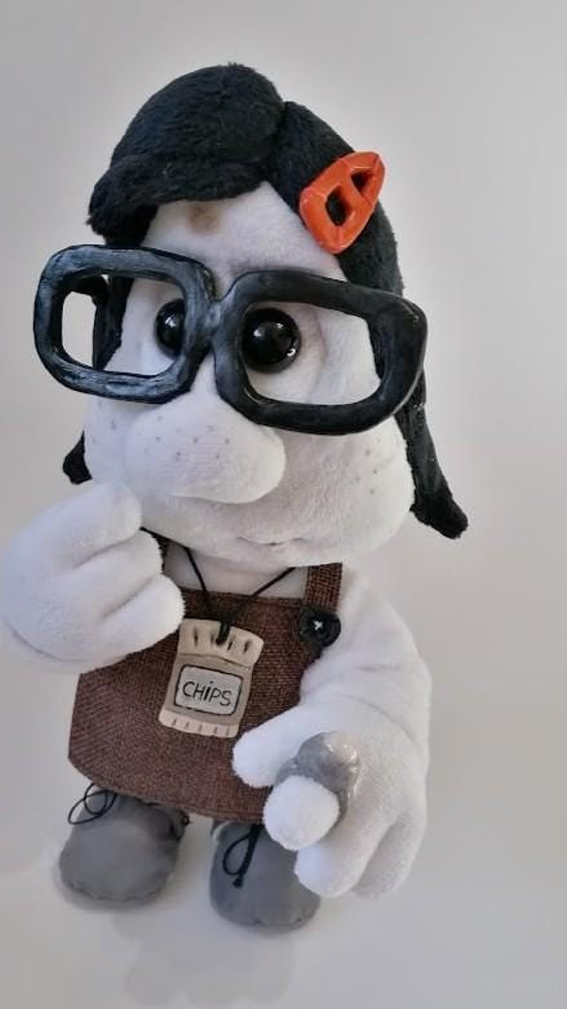 Custom Mary Daisy Dinkle plush doll, hand raised to her chin, thick glasses and orange clip, sewn to order