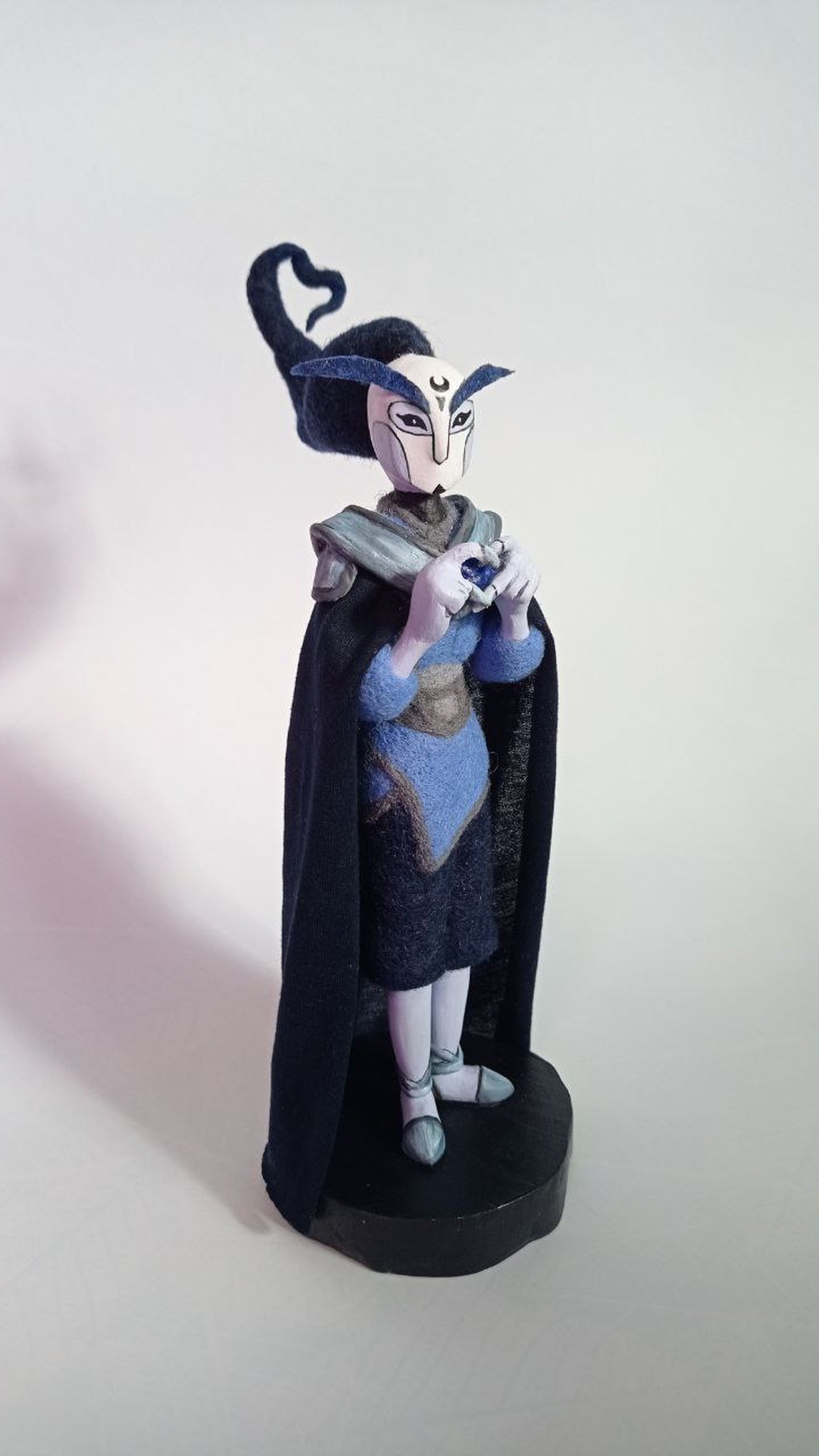 Anime OC doll Midnighter holding a blue felt heart, navy cape and wool hair curl, handmade to order