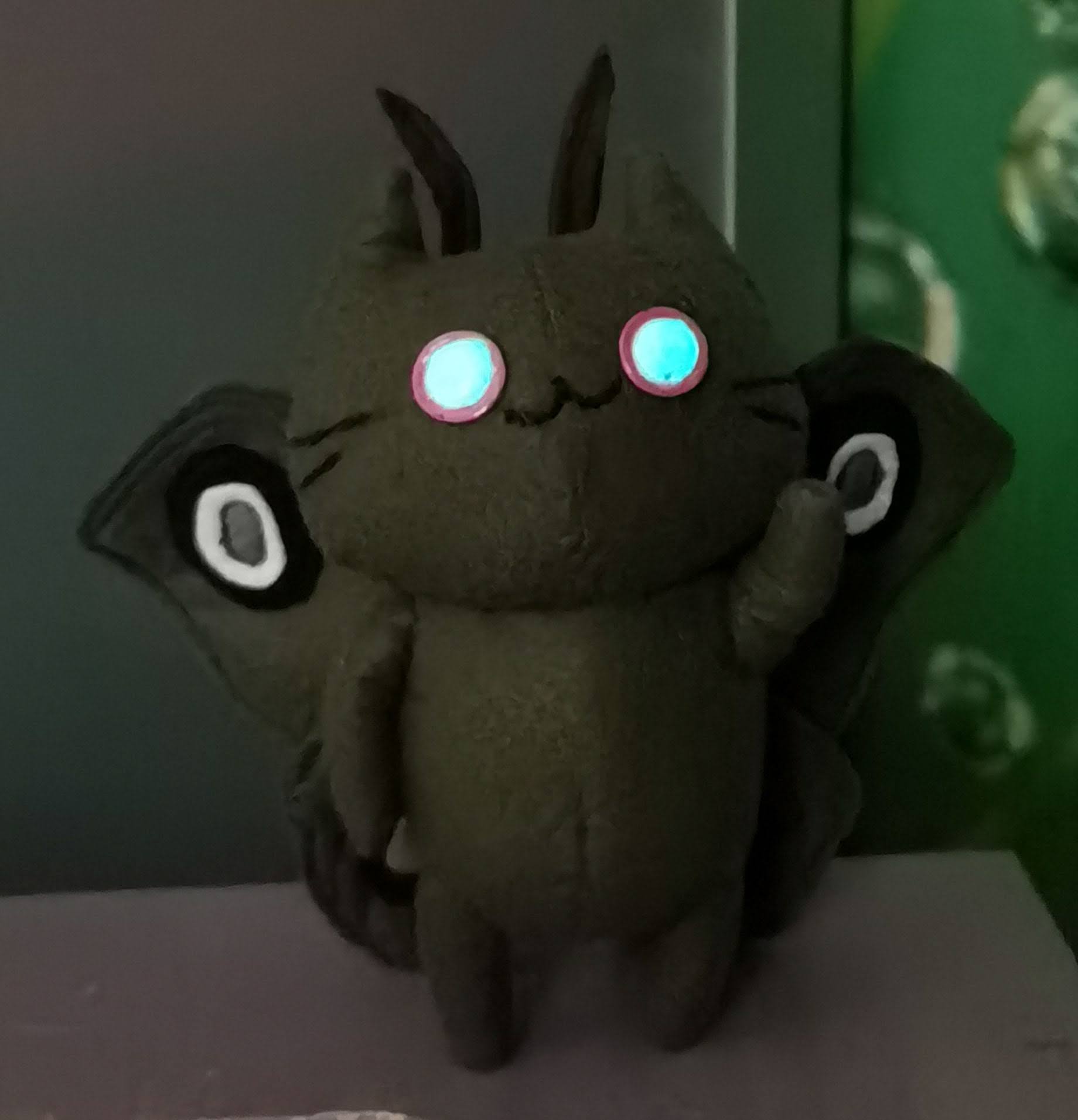 Moth cat plush with eyes that glow in the dark Moth cat plush in a dark room with blue-green eyes that glow in the dark, handmade to order