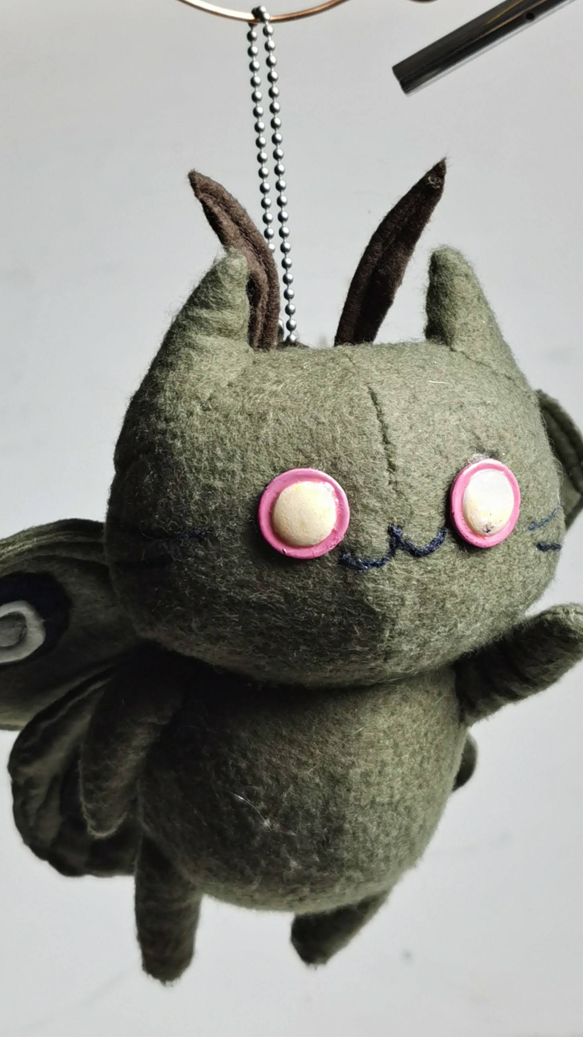 Moth cat plush keychain on a ball chain, olive fleece and pink-rimmed eyes, custom made to order