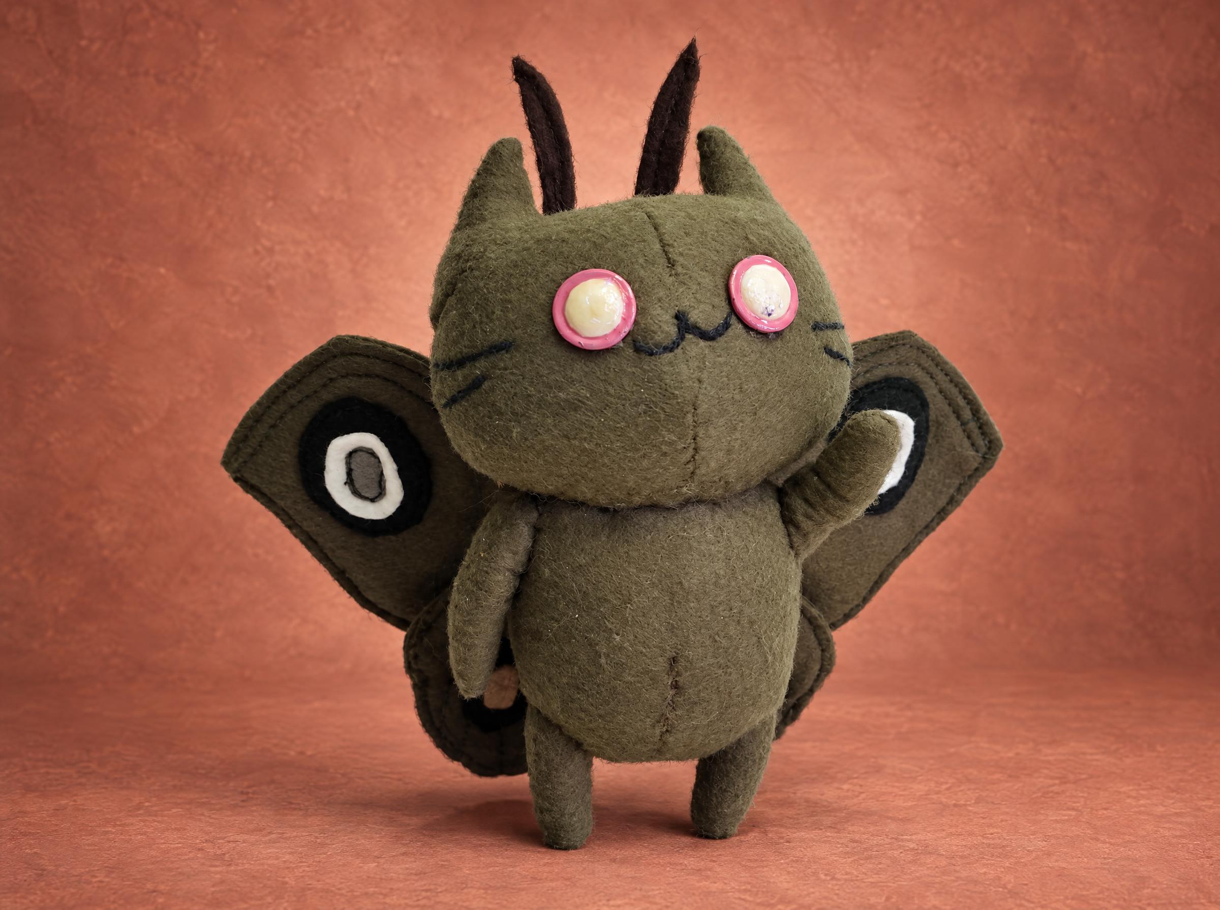 Moth cat plush with olive cat ears, brown antennae and eyespot wings, handmade to order as a small keychain toy