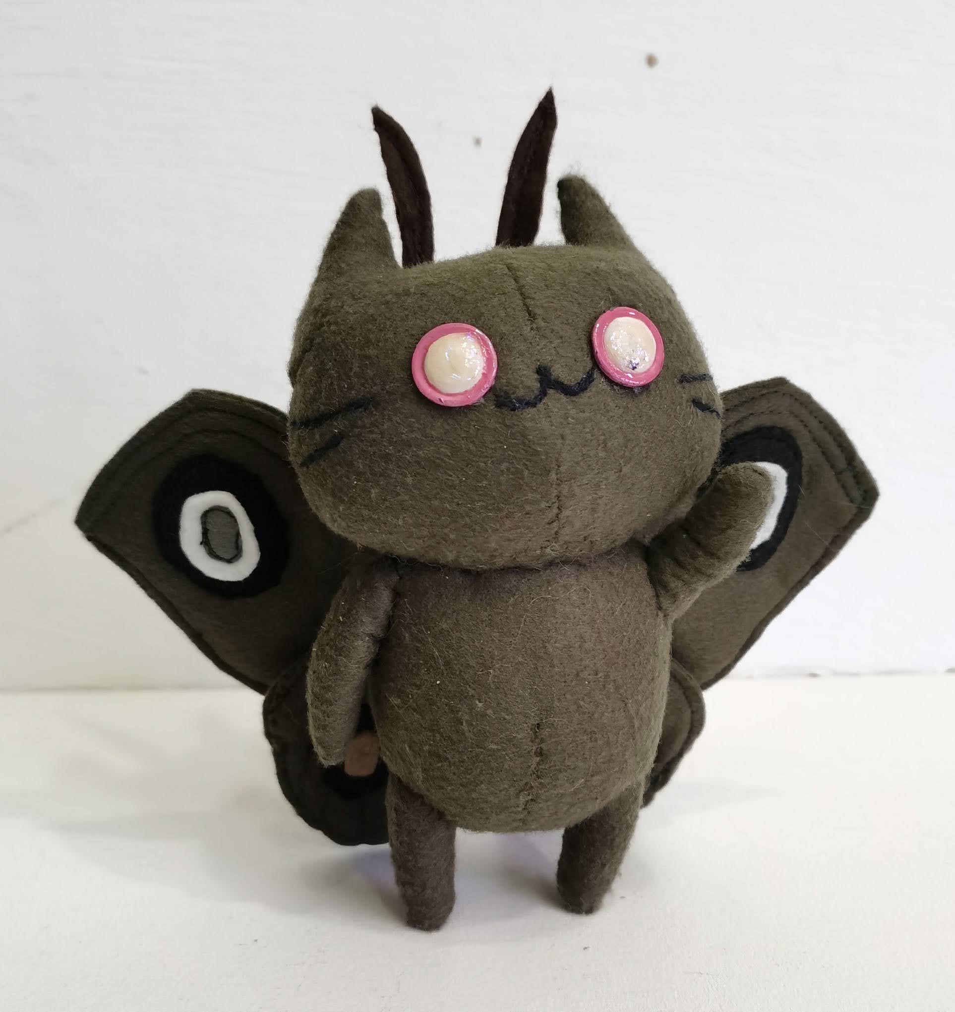 Moth cat plush with eyespot wings Olive green moth cat plush standing with a raised paw and black and white eyespot wings, sewn to order