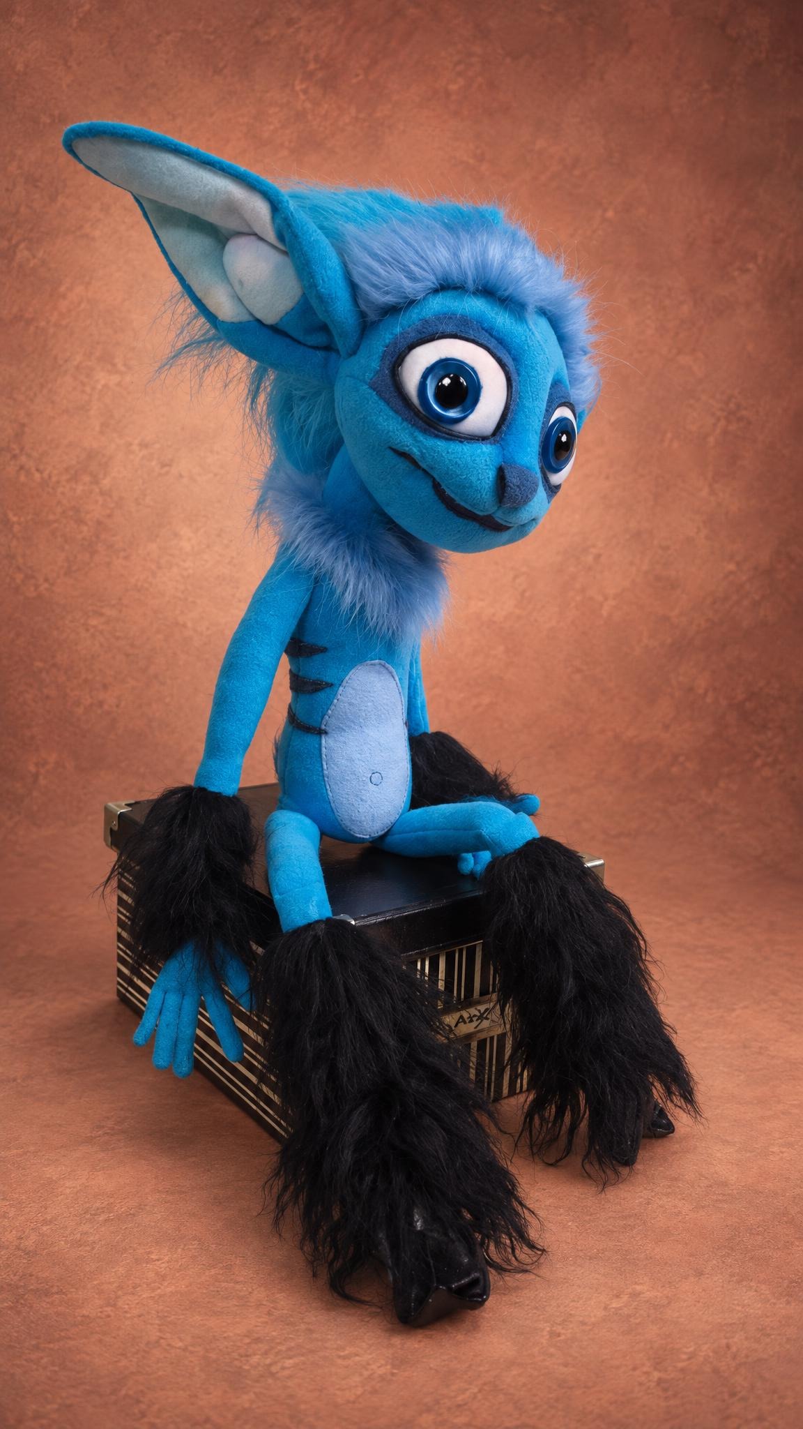 Custom Mune plush, the blue faun from the 2014 film, with huge ears and long black faux fur legs, handmade