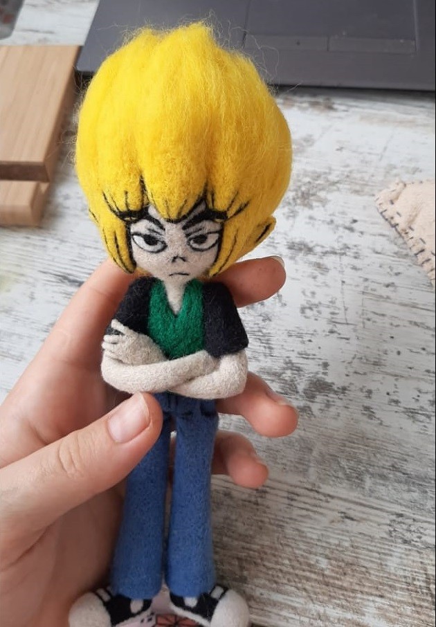 Small needle felted anime doll in a hand Small needle felted anime doll held in one hand, grumpy face with fine black brows and eyes, handmade