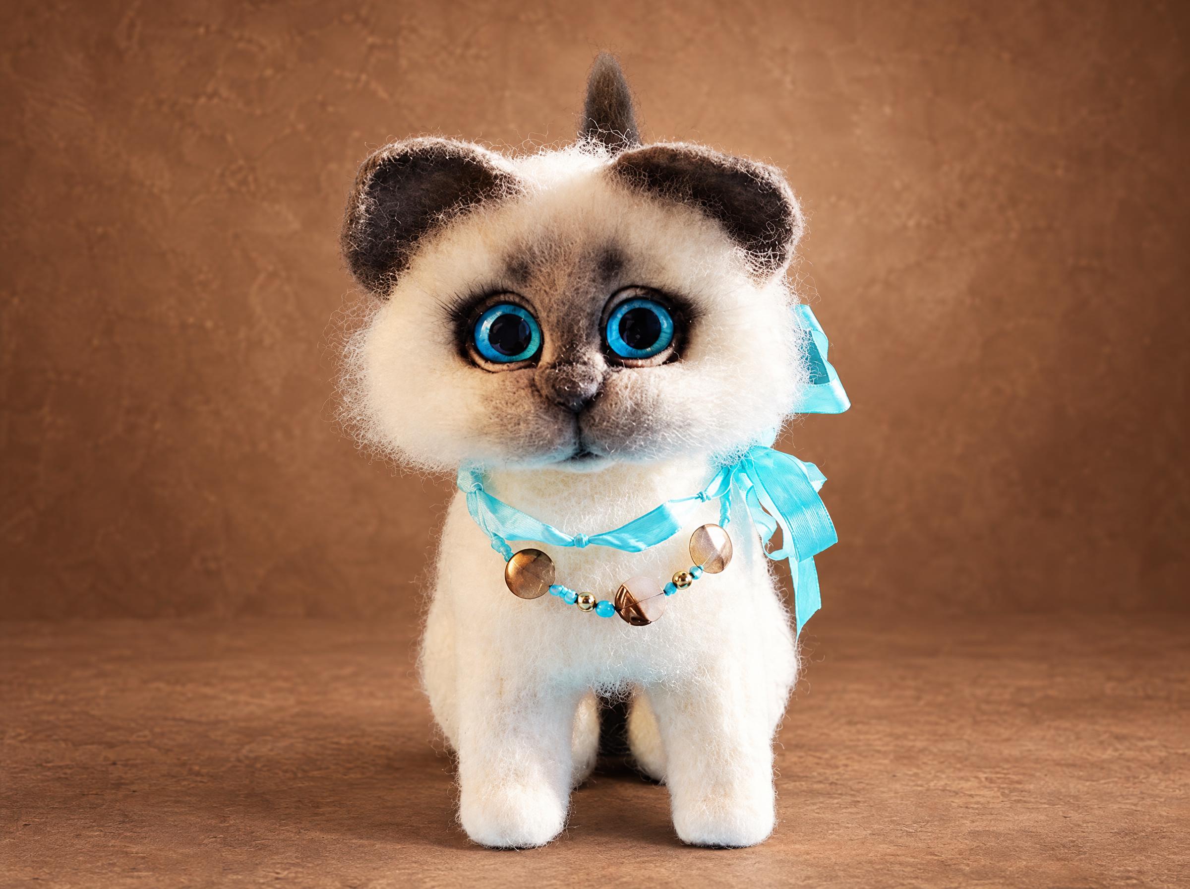 Needle felted kitten in white and grey wool with blue glass eyes and a turquoise silk ribbon, made to order