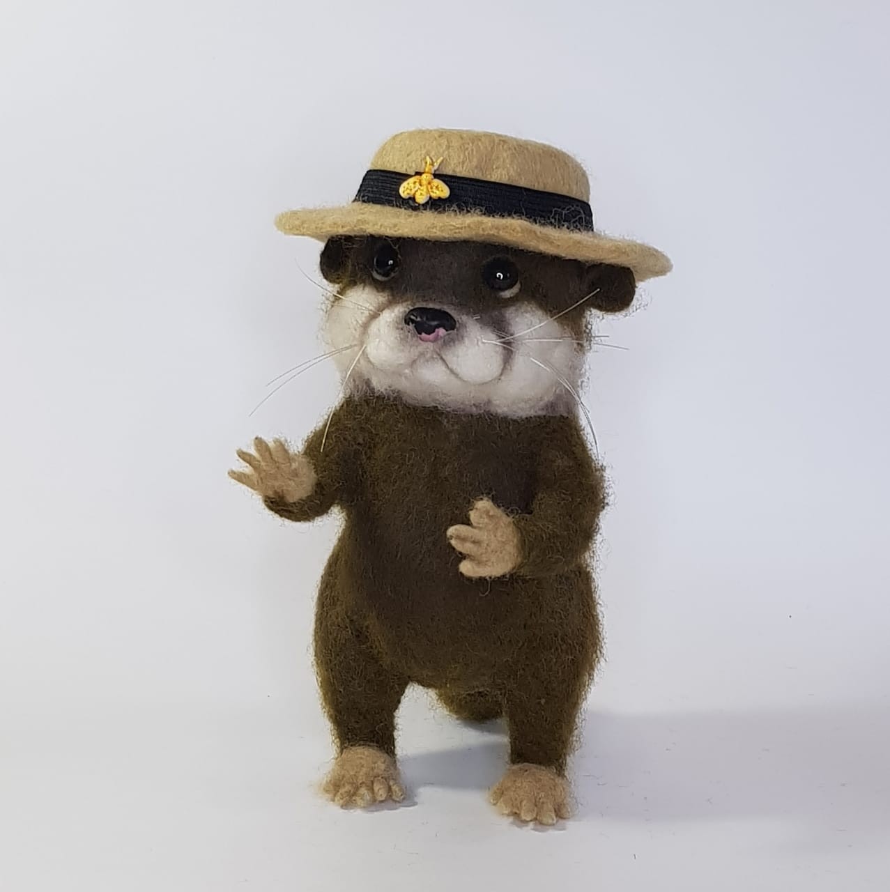 Needle felted otter waving a paw Needle felted otter waving one tan paw, black glossy eyes and long whiskers, boater hat, made to order