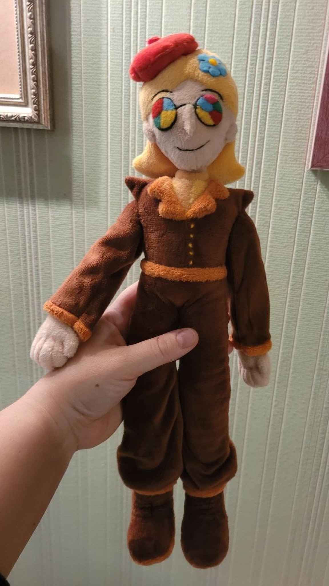 OC plush doll from a drawing held in a hand, made to order: rainbow glasses, stitched smile, brown suit