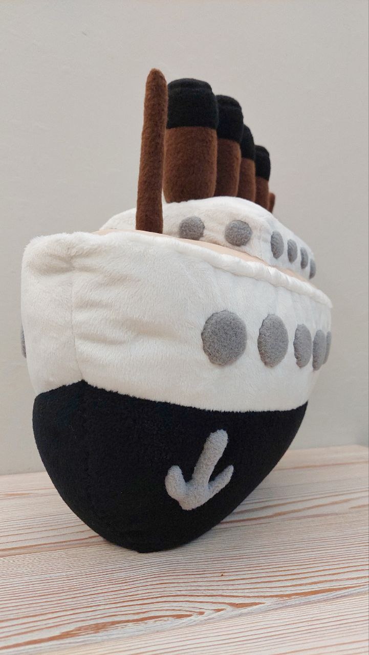 Bow of the ocean liner plush pillow with a gray anchor patch on the black hull, custom handmade ship plush