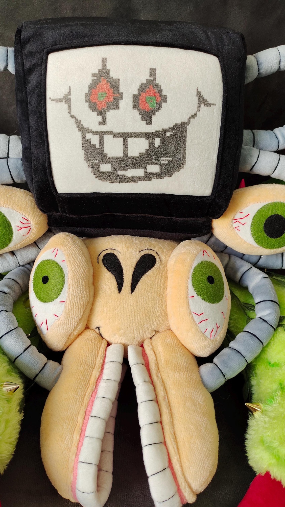 Handmade Omega Flowey plush with a pixel-grin TV head, grey tube vines and long white teeth, sewn to order