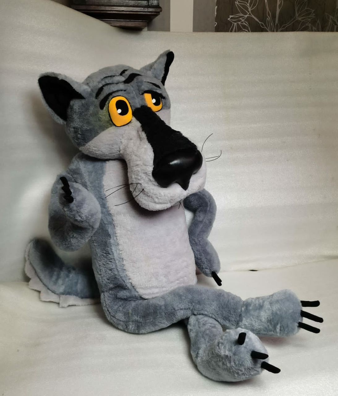 Wolf plush lounging, Once Upon a Dog Once Upon a Dog Wolf plush lounging with one leg stretched out, grey faux fur and black claws, to order