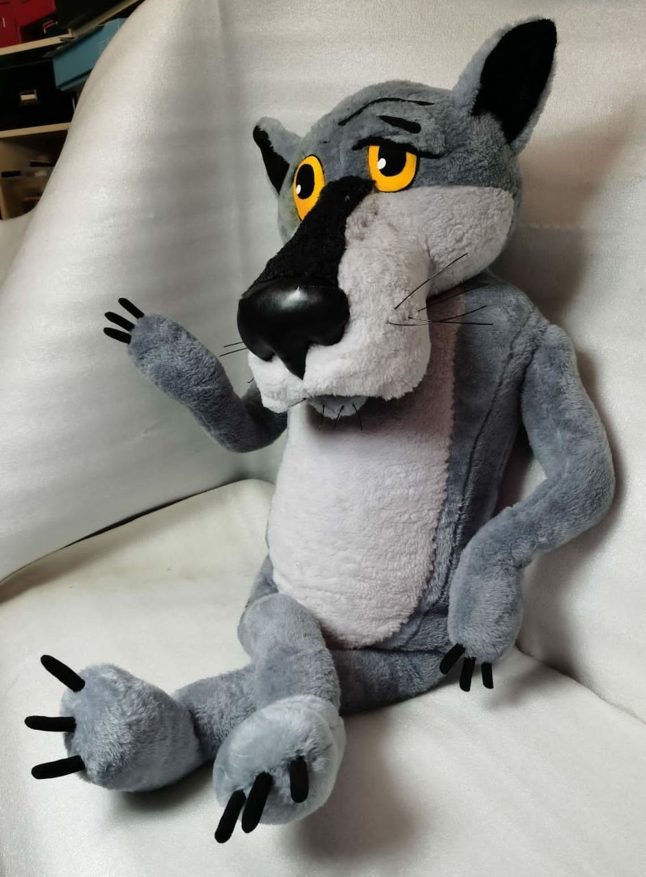 Once Upon a Dog Wolf plush waving Grey Wolf plush from Once Upon a Dog raising a paw, droopy amber eyes and whiskers, made to order