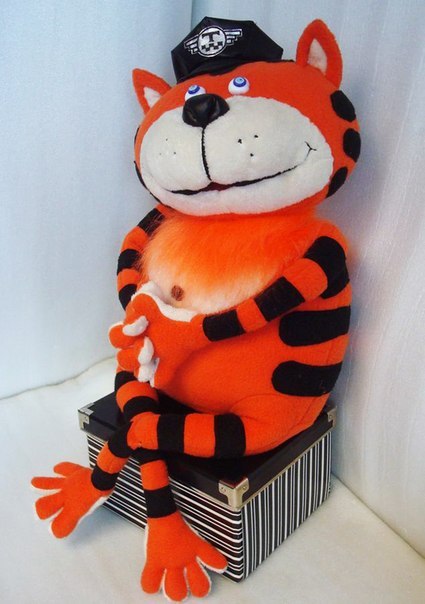 Orange tabby cat plush in a taxi cap, sitting on a box Orange tabby cat plush in a taxi cap sitting on a box, long striped legs hanging down, handmade to order