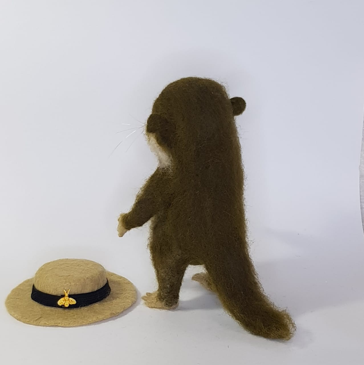 Otter plush with a removable hat Felted otter plush with its removable boater hat on the floor beside it, long tail, made to order