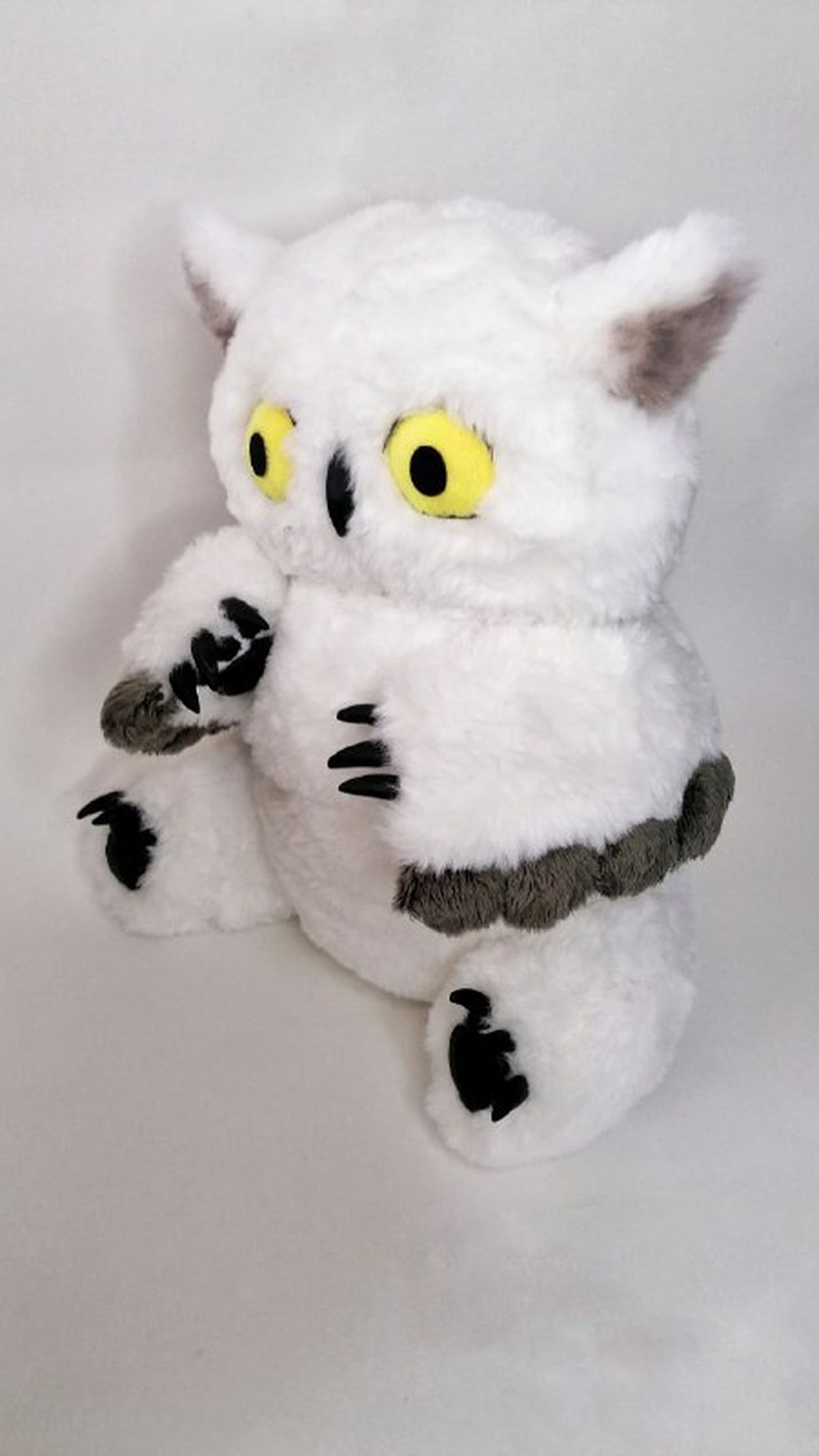 Owlbear plush made to order: grey scalloped feathers on the arms, black claws and wide yellow eyes