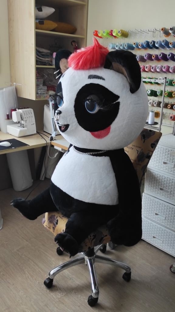 Panda mascot plush in the workshop Panda mascot plush sitting on a chair in our sewing workshop, a custom giant toy made to order