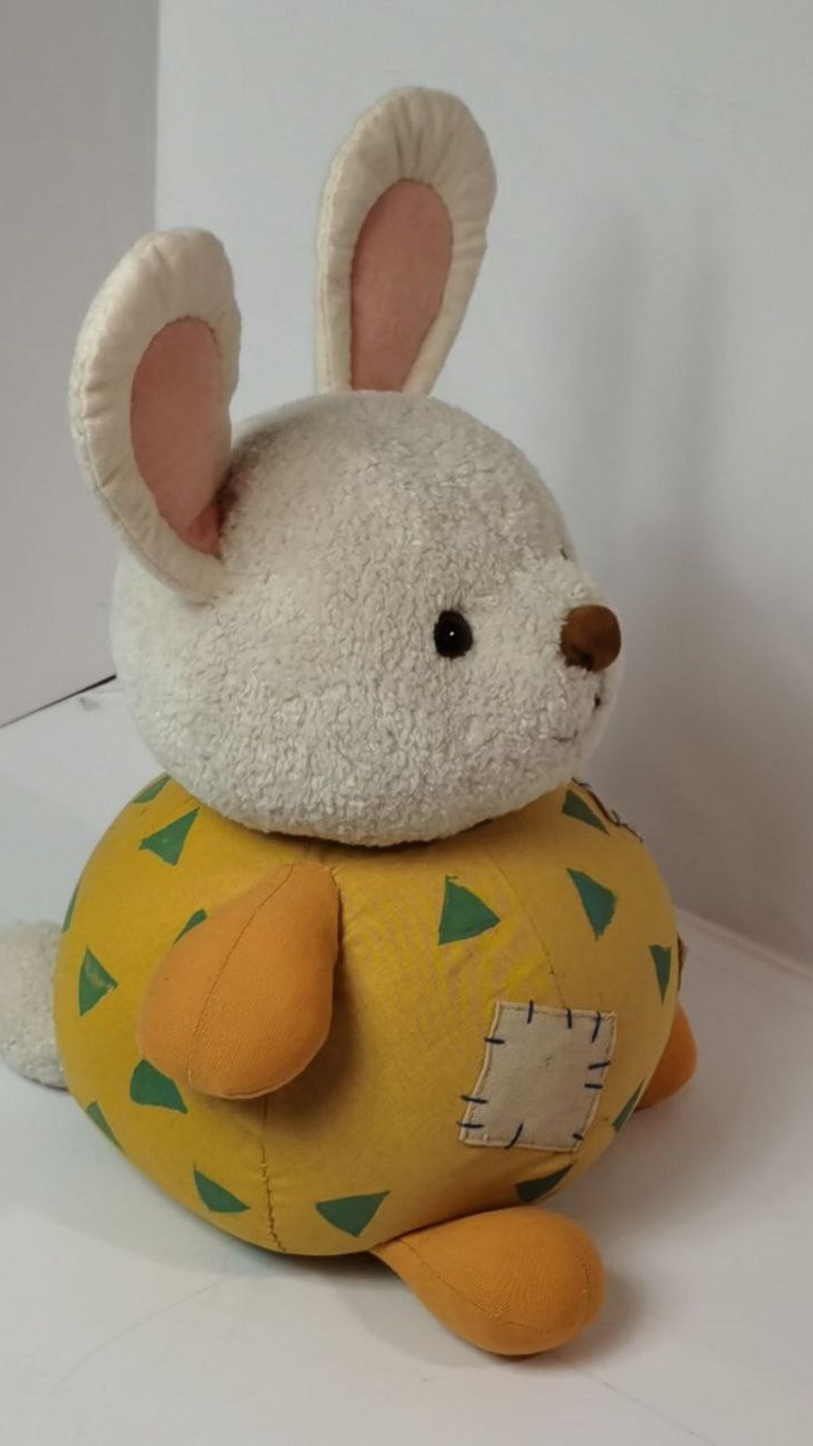 Patchwork bunny plush with orange paws, pink-lined ears and a fluffy white tail, a handmade stuffed animal