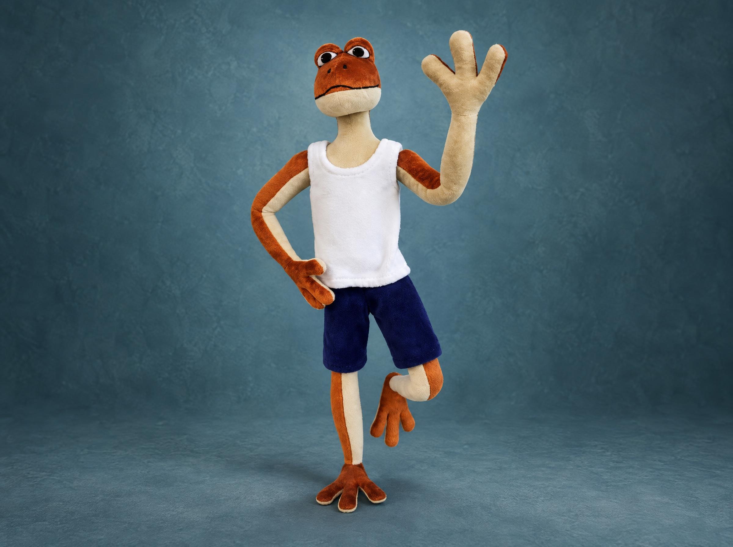 Patila frog plush in a white tank top and navy shorts, waving on one leg, handmade to order